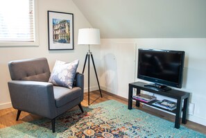 Living room with comfy chair, tv with Google Chromecast for Streaming to TV