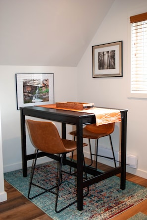 Dining room table, counter height with 2 comfortable chairs.