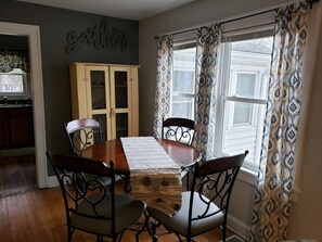 Dining area with vintage cabinet to hold extra serving bowls & other.