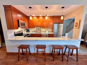 The updated kitchen has granite countertops and a nice open layout with lots of counter space and updated stainless steel appliances
