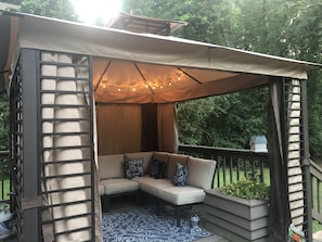 A gazebo on the porch gives a comfortable spot out of the sun and rain