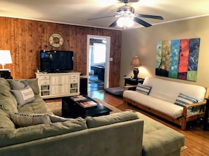 Main living room connected to kitchen. Futon adds extra sleeping. DVD library