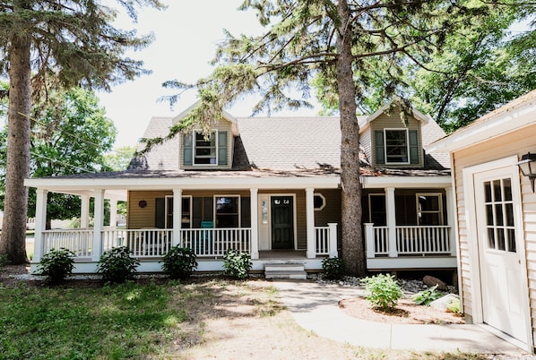 Front of house showing the large wrap around porch which has comfortable furnitu