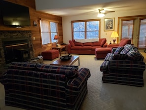 Living room has 3 sofas, one of which is a sleeper, plus a chaise lounge.  