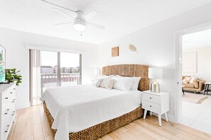 Gorgeous serene master bedroom with a king bed, memory foam mattress, smart TV, balcony access, and a walk-in closet.
