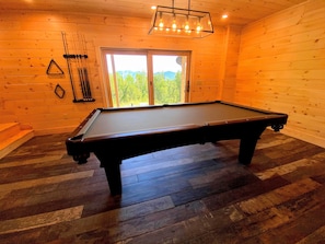 Enjoy the pool table in the lower level area and access to the back yard!