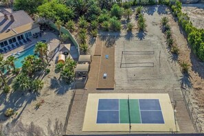 Your private resort has everything — sand volleyball, pickleball, bocce, basketball, shaded lounges, a custom barrel sauna, and a dreamy pool just steps away.