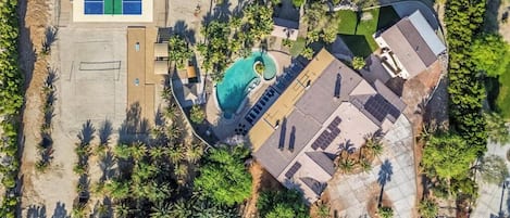 Zoom out and feast your eyes on the ultimate backyard glow-up — a desert resort-style playground carved right into the palms.