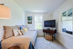 The living room has a TV area and a day bed to relax/sleep.
