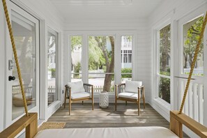 SCREENED FRONT PORCH WITH SEATING AND BED SWING