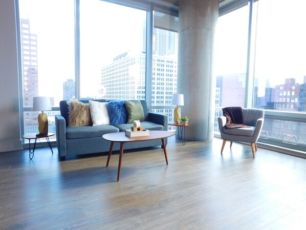 Living area with queen sleeper sofa and floor to ceiling windows
