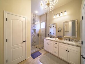 Swarovski crystal chandelier and custom travertine shower. 
