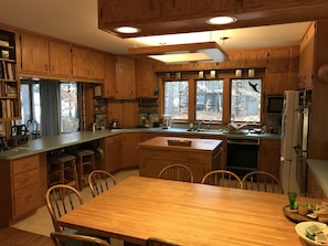 Kitchen with breakfast table and view to yard