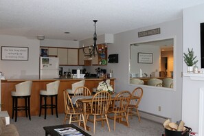 Dining area between living room and kitchen with a 12' long counter and stools