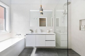 Main bathroom (located upstairs) with shower, bath, and basin
