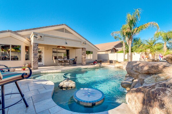 Relax around the built in custom table in the pool