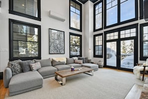 Living Room with Soaring Ceilings, a Wall of Windows & AC Unit - Main Floor