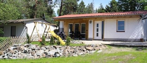 Großer Garten mit überdachter Terrasse und Kinderspielplatz