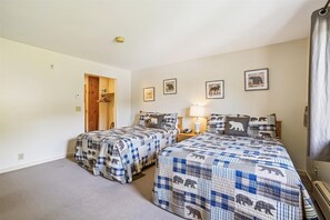 Spacious bedroom with two double beds.