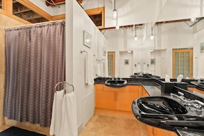 Bathroom 1 off of the front hallway features double vanities and a shower.