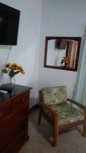 Accent chair, dresser, wall -mirror, TV and AC in the bedrooms