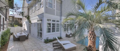 Patio with Dining Table, Chairs, Lounge Chairs, and the Pool.