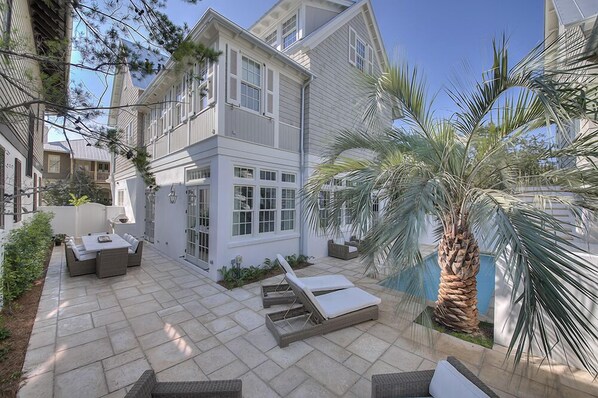 Patio with Dining Table, Chairs, Lounge Chairs, and the Pool.