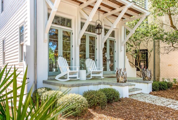 Pavered Deck with Two Outdoor Rocking Chairs.