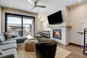 Living Area with Sectional, Fireplace, TV, and Patio Access