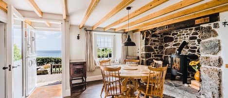 Prospect House, Coverack. Ground floor: Dining room with stunning sea views and  inglenook fireplace