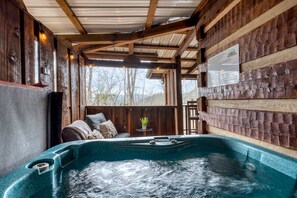 Large hot tub in a secluded nook for privacy.