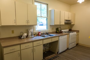 Galley kitchen-dishwasher, gas range, microwave, coffee maker, freezer/fridge