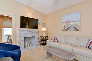 A warm and spacious living room with a decorative fireplace.