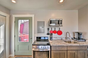 The well-equipped kitchenette features stainless steel appliances and a Keurig.