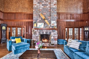 The original stone fireplace spans the cathedral ceilings