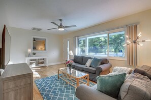 Main family room with huge picture window, hardwood flooring and large flat screen TV with Cable.