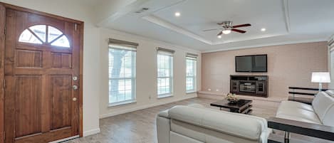 Living Area with Leather Sofas and Recliner and 65" TV with over 400 channels