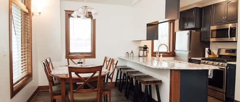 Dining room with table & chairs for 6;  4 bar stools for counter seating.