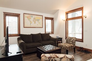 Vaulted ceiling in living room, natural lighting, card and board games for fun.