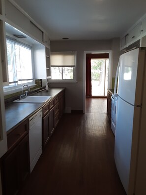 Galley kitchen looking into the living room.