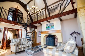 double height sitting room with log burner