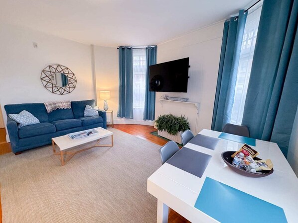 Living Room, with TV mounted to wall for easy viewing from either the couch or dining table