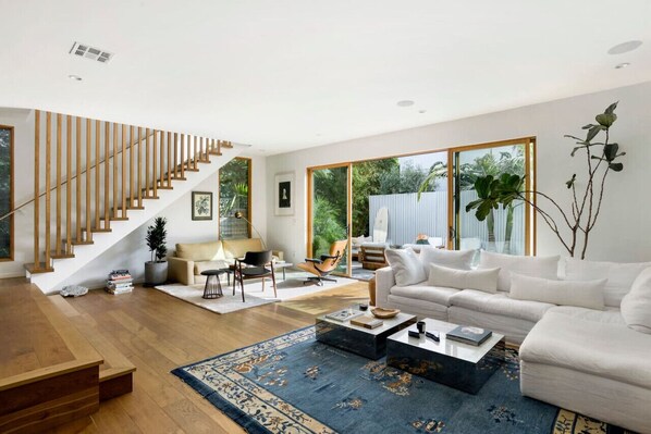 Spacious and stylish living room featuring a luxurious, cozy seating, and a state-of-the-art entertainment system.