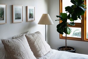 Cozy and elegant—soft pillowcases paired with a stylish white lamp for a restful night