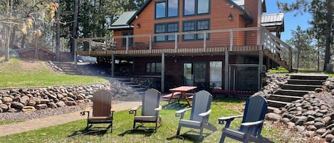 Walkout to firepit on lakeside of house.