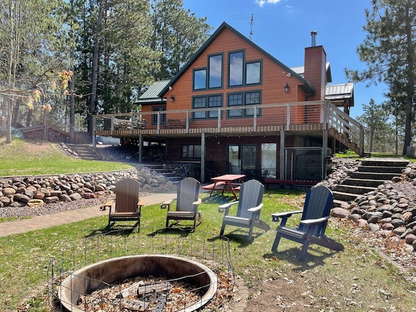 Walkout to firepit on lakeside of house.