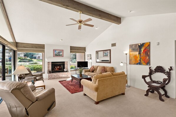 The living area is spacious with full height windows letting in both natural light and gorgeous views