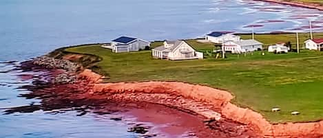 We are on the ocean front to the right of the cottage on the point, black roof.