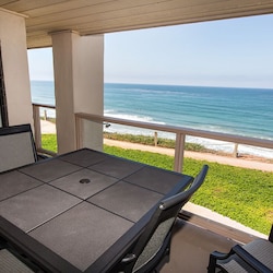 Oceanfront balcony above interior grounds/walkway