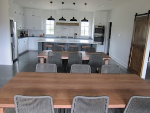 Well equipped kitchen , opens into dining room with two large tables